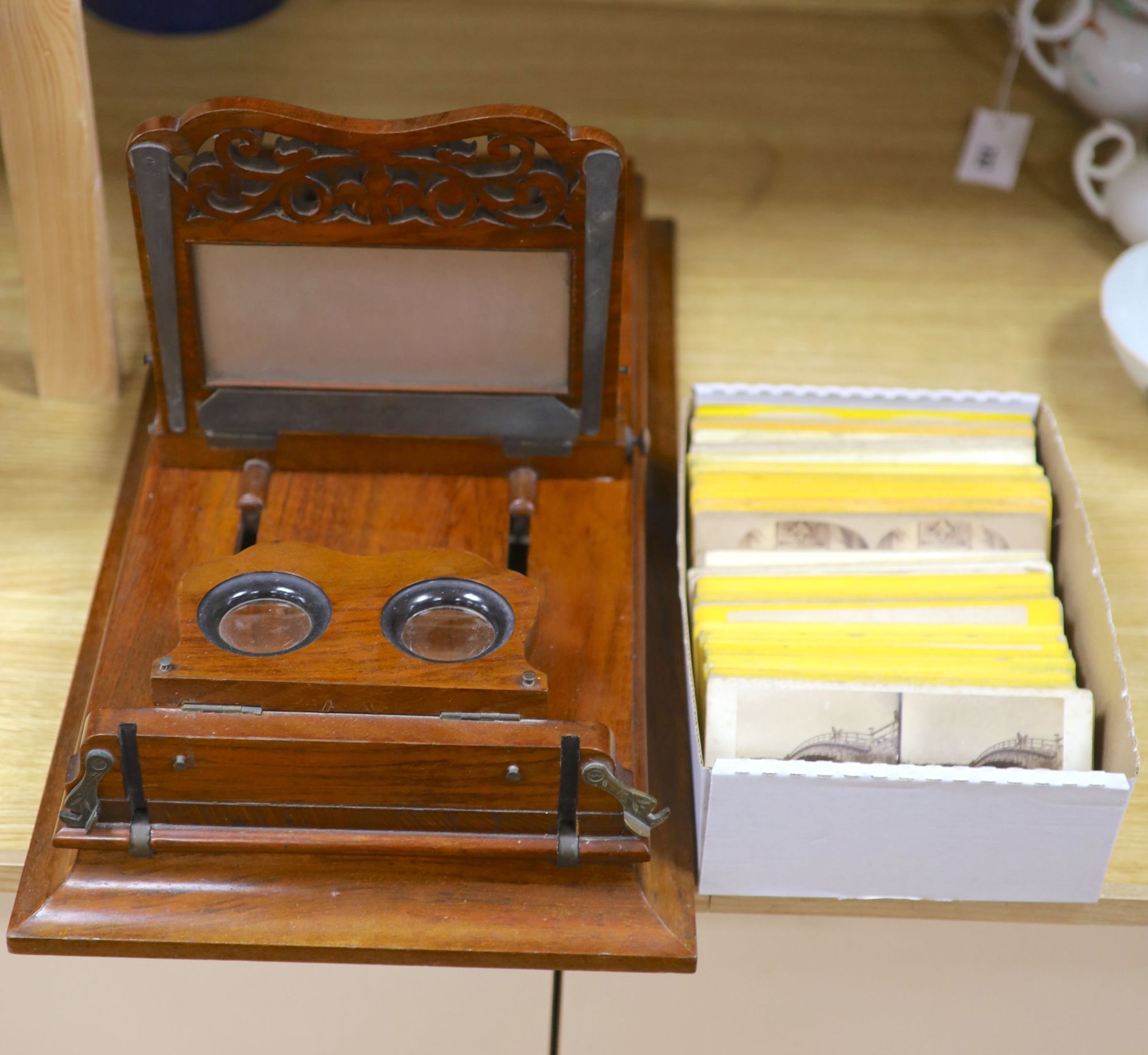 A large Victorian walnut stereoscopic card viewer with slides, Football at Eton etc, length 58cm width 30cm height 28cm